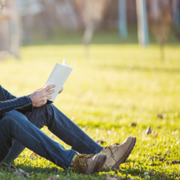 tricks to find inspiration - blog image - man reading on grass